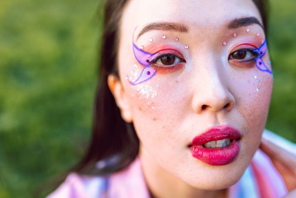 trans women butterfly makeup photoshoot in grass