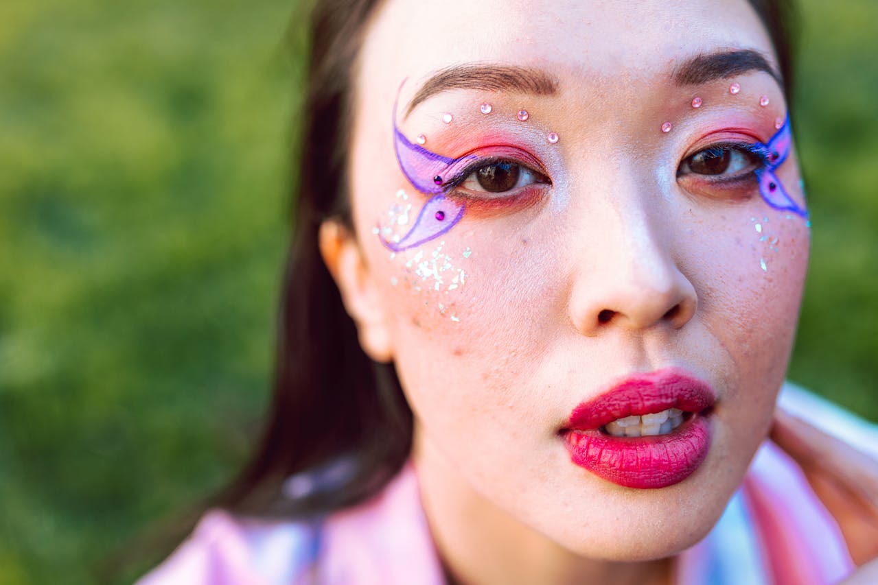 trans women butterfly makeup photoshoot in grass